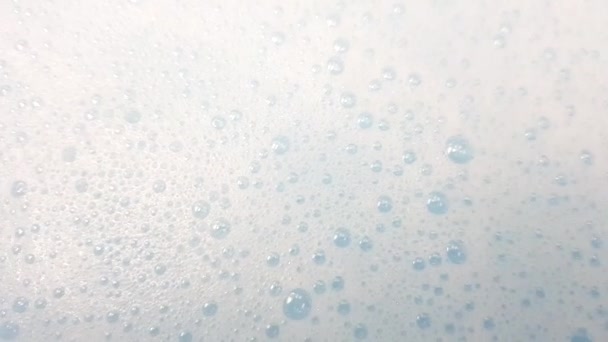 White Foam Bubbles Popping Clear Blue Water Closeup — Stock Video