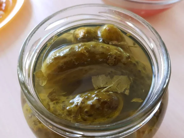 Picked cucumbers in jar closeup on the table. — Stock Photo, Image