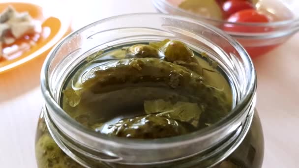 Picked cucumbers in jar closeup on the table. — Stock Video