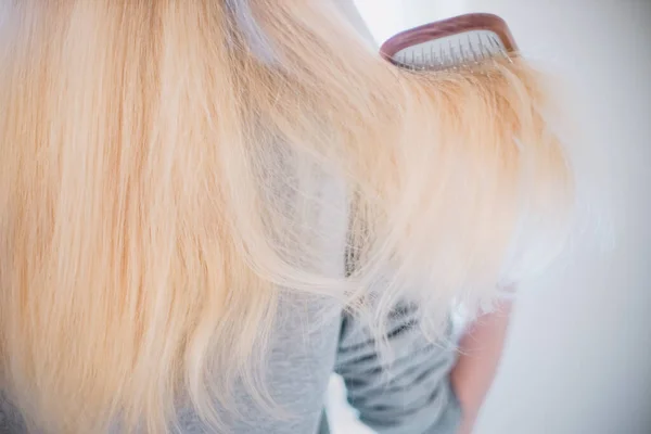 Young Woman Combing Long Blond Hair Wooden Comb Rear View — Stock Photo, Image