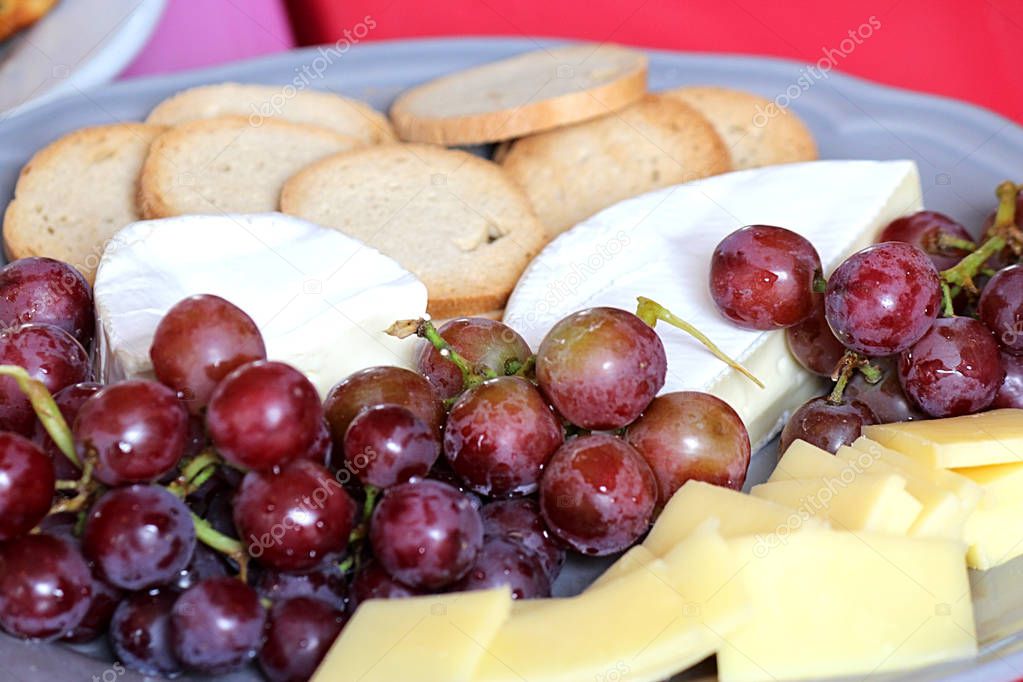 Platter of fresh fruits, cracker and cheese.