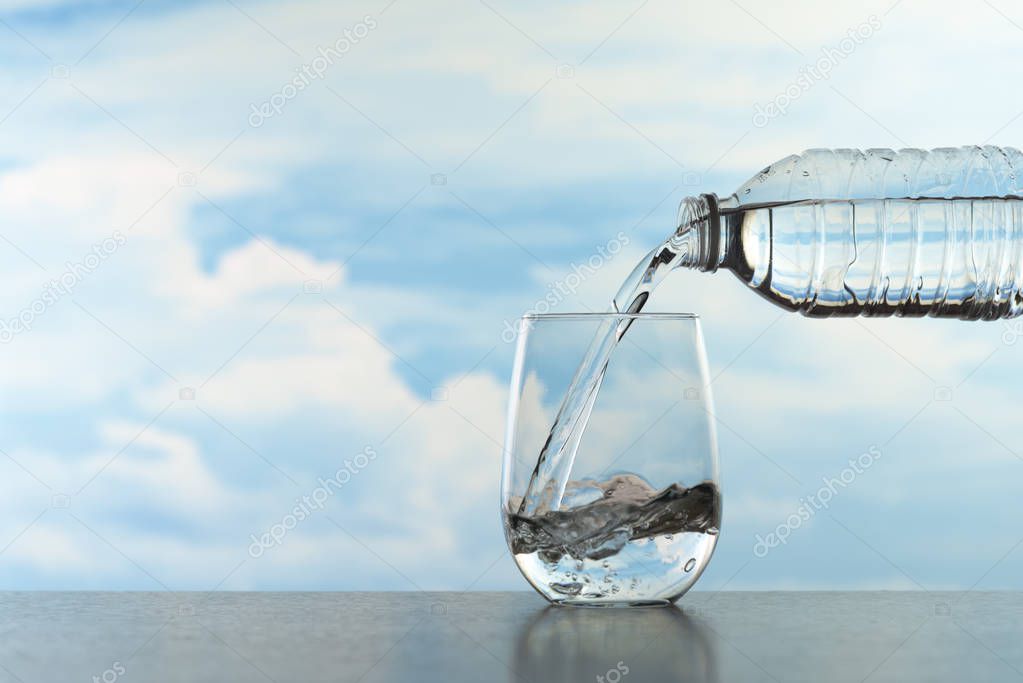 Water splashing in a transparent glass after pouring water