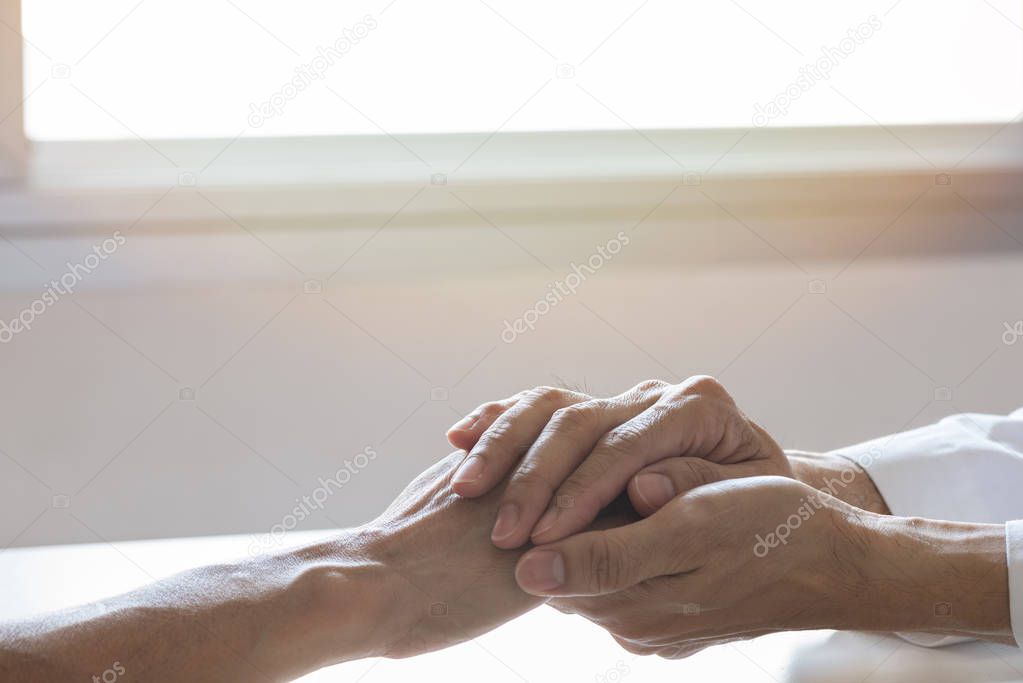 Doctor holding a patient hand