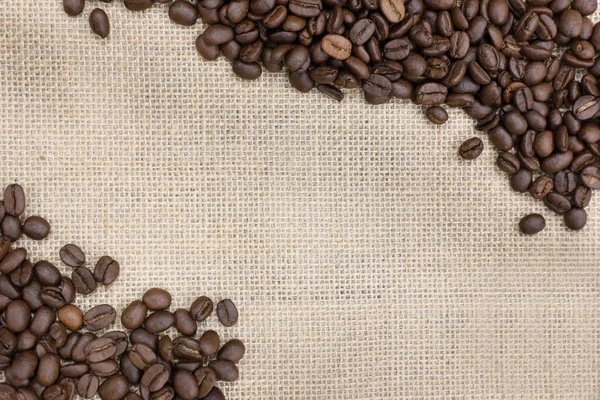 Roasted coffee bean on a  burlap sack — Stock Photo, Image