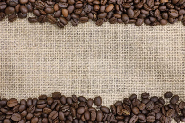 Roasted coffee bean on a  burlap sack — Stock Photo, Image