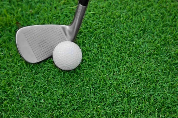 Iron golf club and ball on a green grass — Stock Photo, Image