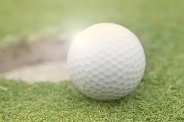 Golf ball on lip of cup — Stok fotoğraf