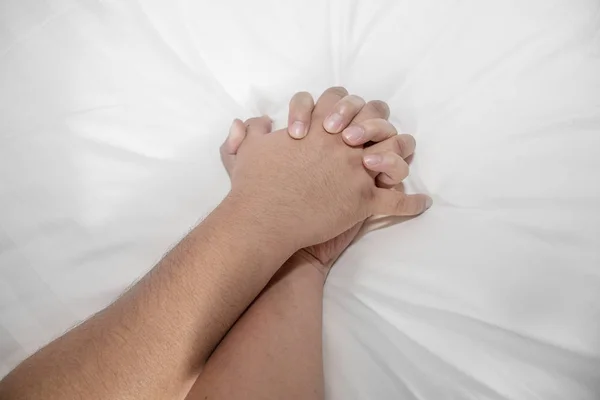 a man hand grabbing other man hand while having sex
