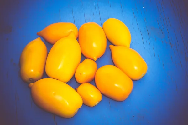 Yellow Tomato on Blue Table Retro — Stock Photo, Image