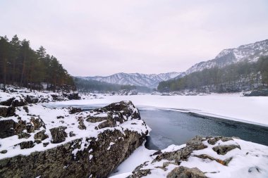 Karla kaplı dağlar ve dağ nehri manzarası