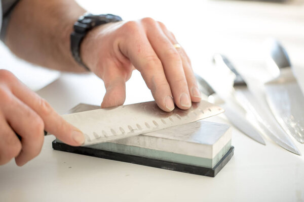 Man sharpens the knife