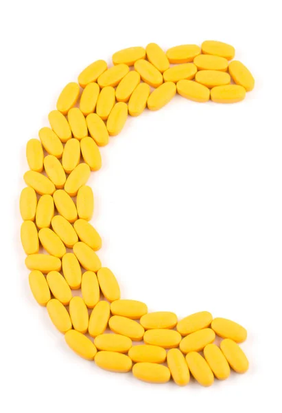 Comprimidos de vitamina C em forma de letra — Fotografia de Stock