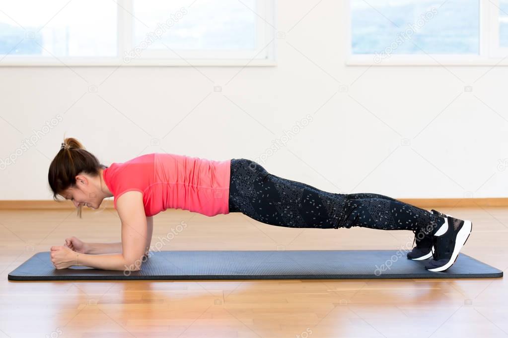 Active young woman exercising 