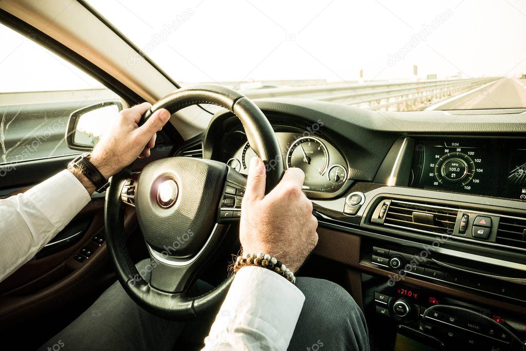 Bussinessman driving luxury car