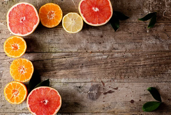 Citrus fruits on wooden table — Stock Photo, Image