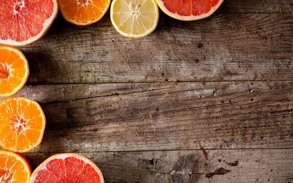 Citrus fruits on wooden table — Stock Photo, Image