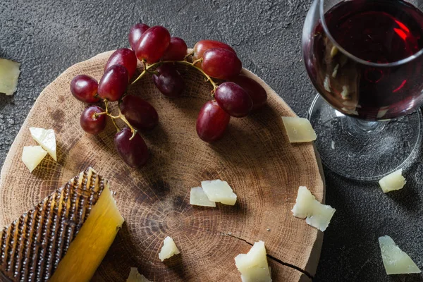 红葡萄与一杯红酒的木切碎西班牙硬奶酪乳酪 — 图库照片