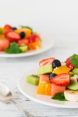 Ahşap masa üzerinde taze meyve salatası. Yakın çekim