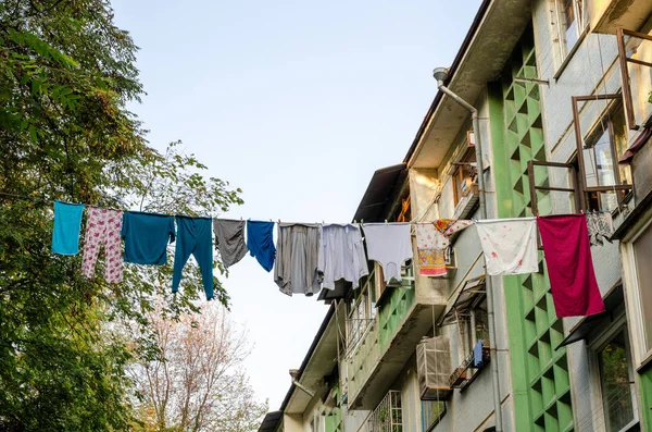 Multi-colored laundry on a rope high in the air. Sochi authenticity