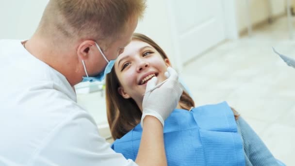 Dentist doctor treats a female patient s teeth at the clinic