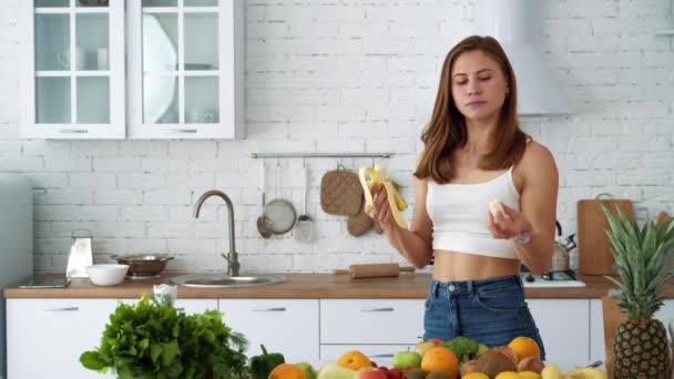 Wesoła Dziewczyna Banana Białej Kuchni Stołem Warzywami Owocami — Wideo stockowe