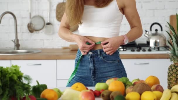 Girl Measures Her Waist Kitchen Table Vegetables Fruits — Stock Video