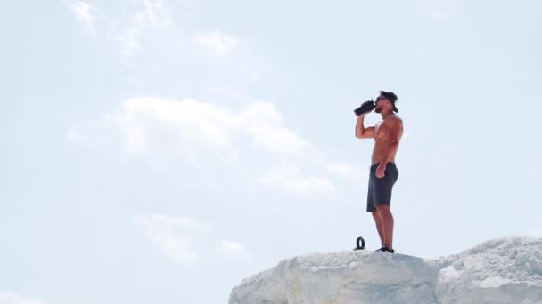 Athletic Man Drinks Energy Drink Bottle Training Outdoors Slow Motion — Stock Video