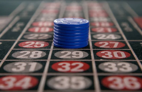 Gambling on a roulette table with blue chips — Stock Photo, Image