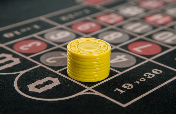 Gambling on a roulette table with yellow chips — Stock Photo, Image