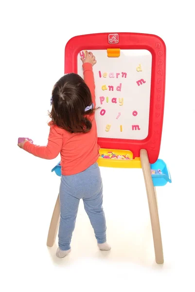 Niña jugando con el tablero del imán — Foto de Stock