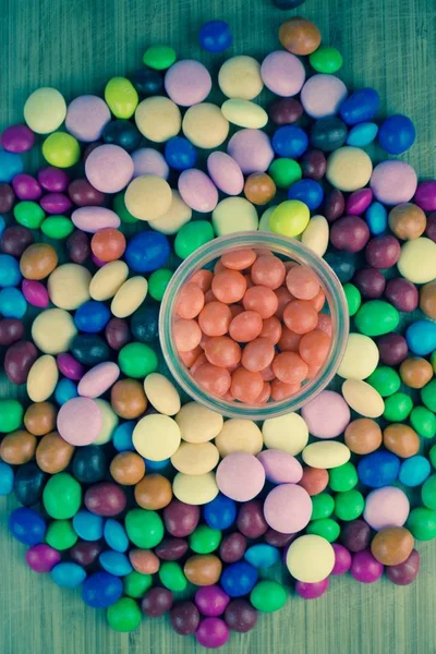 Orange sweets in glass jar — Stock Photo, Image