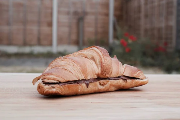 Tasty croissant in garden — Stock Photo, Image