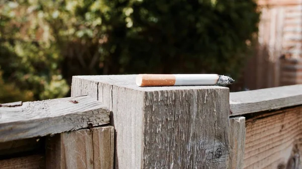 Cigarette on the wooden wall — Stock Photo, Image