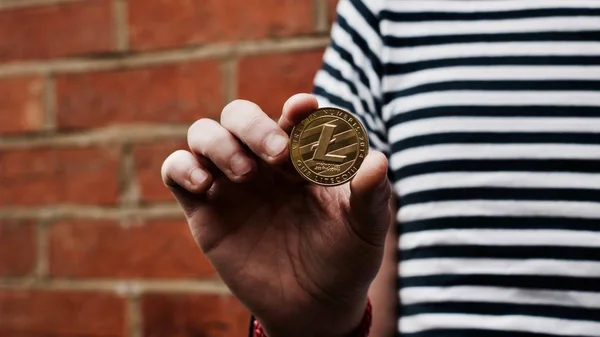 Gold Litecoin in hand — Stock Photo, Image