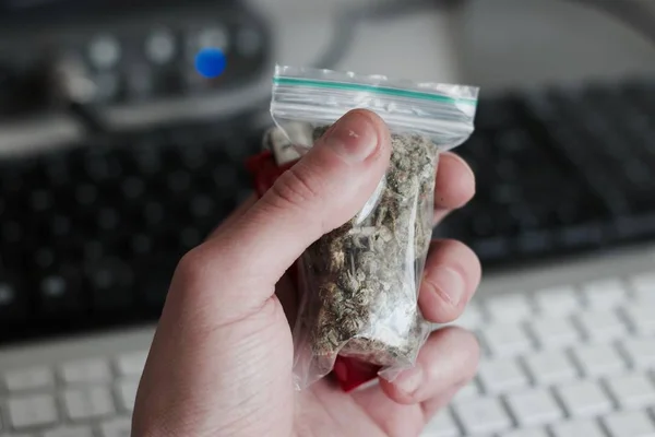 Bolsa con una marihuana en la mano — Foto de Stock