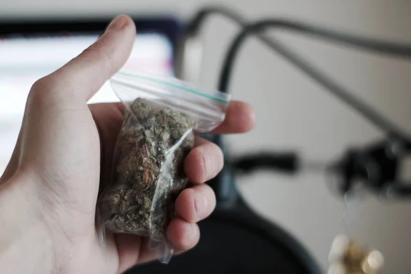 Bolsa con una marihuana en la mano — Foto de Stock