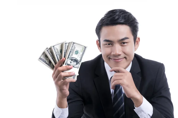 Jovem empresário segurando dinheiro no fundo branco — Fotografia de Stock
