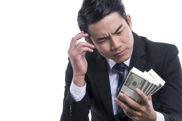 Portrait of young businessman thinking about dollars in hand — Stock Photo, Image