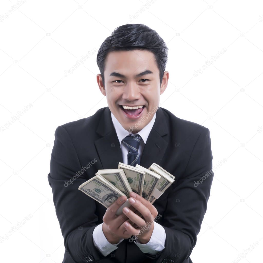 Young businessman holding money on white background