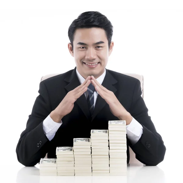 Young businessman making the shape of house roof over strack ban — Stock Photo, Image