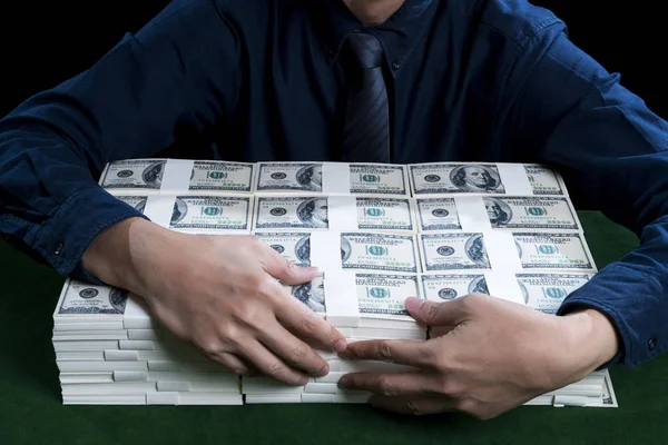 The rich man hugging the bundles of dollars — Stock Photo, Image