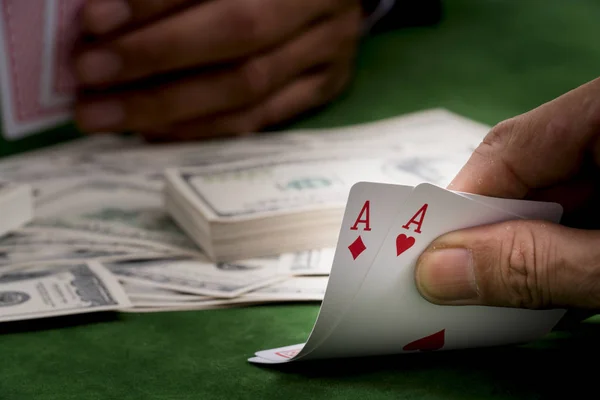 Close up of poker player with cards and money sheet at green cas — Stock Photo, Image