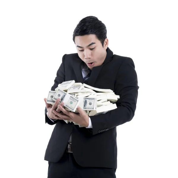 Businessman holding a big pile of money in his arms on white bac — Stock Photo, Image