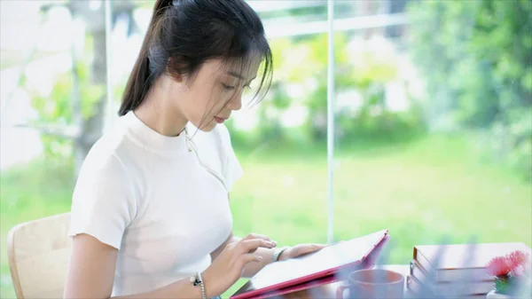 Close up Asian teenage typing on tablet in garden — Stock Photo, Image