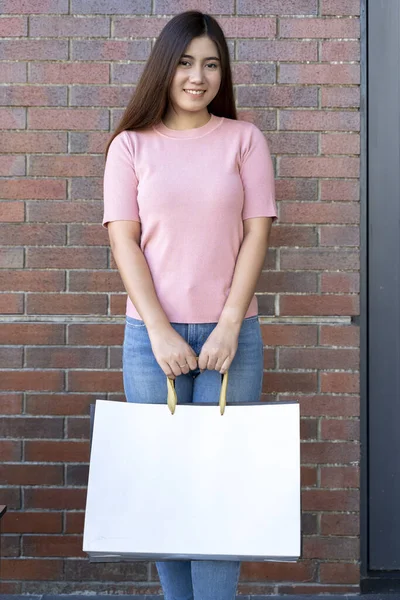 Young female holding two bag, mockup blank screen paper shopping bag with clipping path, Empty space on shopping bag for design insert logo or graphic.