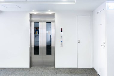 Modern binadaki asansör, kapalı kapı çıkış kapısının yanında duruyor, birinci katta bekleyin, arka plan için görüntü veya reklam grafik tasarımı ekleyin