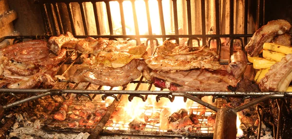 Matlagning kött på grillen i den stora öppna spisen — Stockfoto