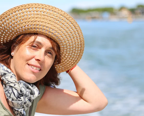 Beautiful forty year old woman with straw hat — Stock Photo, Image