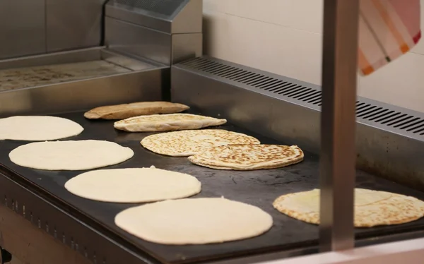 Many piadine on the hot plate of a restaurant in Italy — Stock Photo, Image