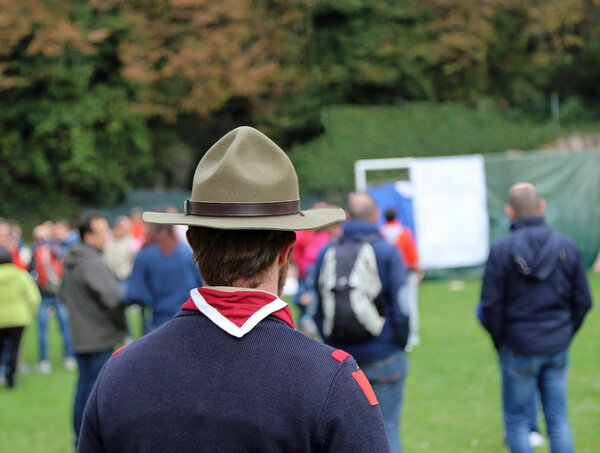 scout at meeting in uniform with campaign hat